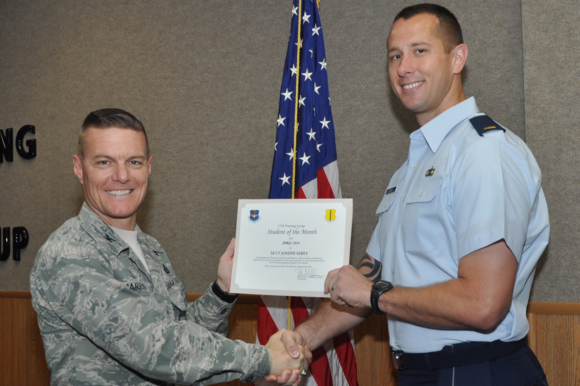 GOODFELLOW AIR FORCE BASE, Texas -- Col. Brendan M. Harris, 17th Training Group Commander, presents the 315th Training Squadron Officer Student of the Month award for April 2014 to 2nd Lt. Joseph Q. Sebey May 2. (U.S. Air Force photo/ Airman 1st Class Breonna Veal)