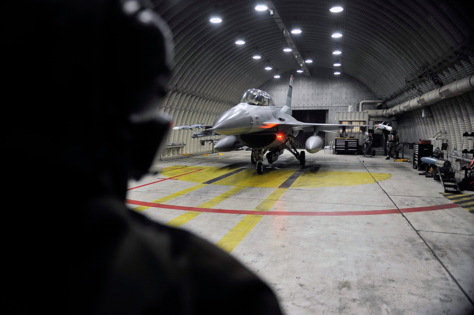 Senior Airman Mario Quintana, 36th Aircraft Maintenance Unit crew chief, prepares to release the F-16 pilot for take off after Airmen were released to continue their mission during a theater ballistic missile attack scenario May 8 on Osan Air Base, Republic of Korea. The 25th and 36th Fighter Squadrons are key to helping United States Forces and South Korea maintain stability on the Korean peninsula. (U.S. Air Force photo by Senior Airman David Owsianka)