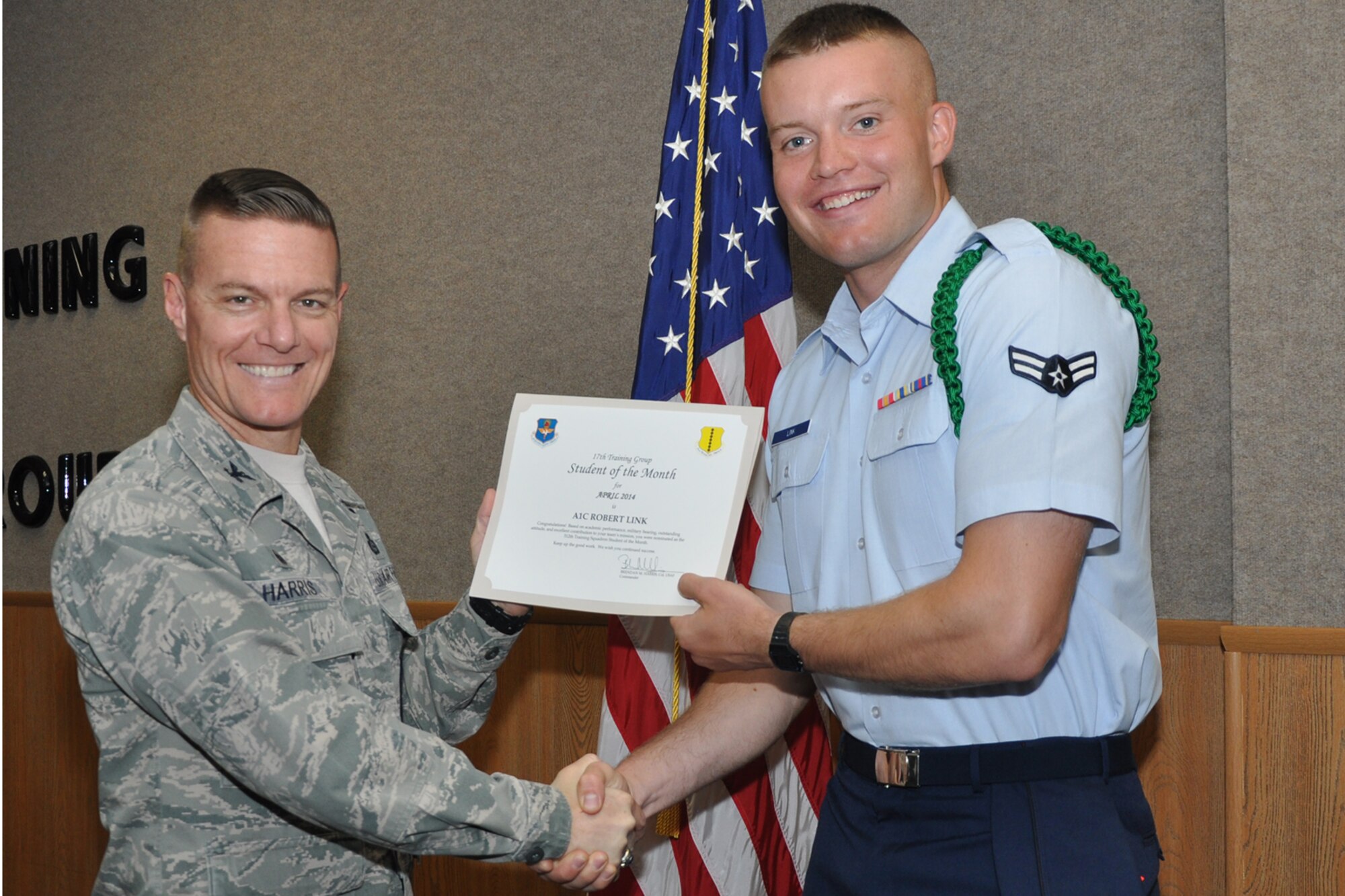 GOODFELLOW AIR FORCE BASE, Texas -- Col. Brendan M. Harris, 17th Training Group Commander, presents the 312th Training Squadron Enlisted Student of the Month award for April 2014 to Airman 1st Class Robert Link May 2. (U.S. Air Force photo/ Airman 1st Class Breonna Veal)