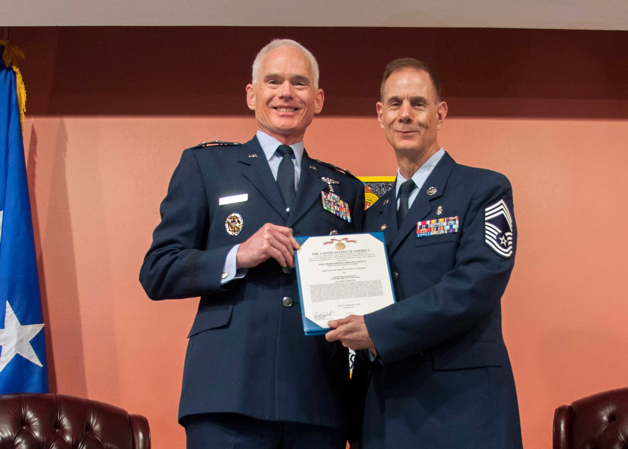 TRAVIS AIR FORCE BASE, Calif. -- Maj. Gen. Paul Dwan, mobilization assistant to the Surgeon General of the Air Force, presents the meritorious service medal to Chief Master Sgt. Neil Curchin, 349th Medical Squadron medical administrative manager, during a retirement ceremony April 27, 2014, at Travis Air Force Base, Calif. Dwan is a former commander of the 349 MDS; Curchin has worked for 11 different 349 MDS commanders during the course of his career. (U.S. Air Force photo/Master Sgt. Rachel Martinez)