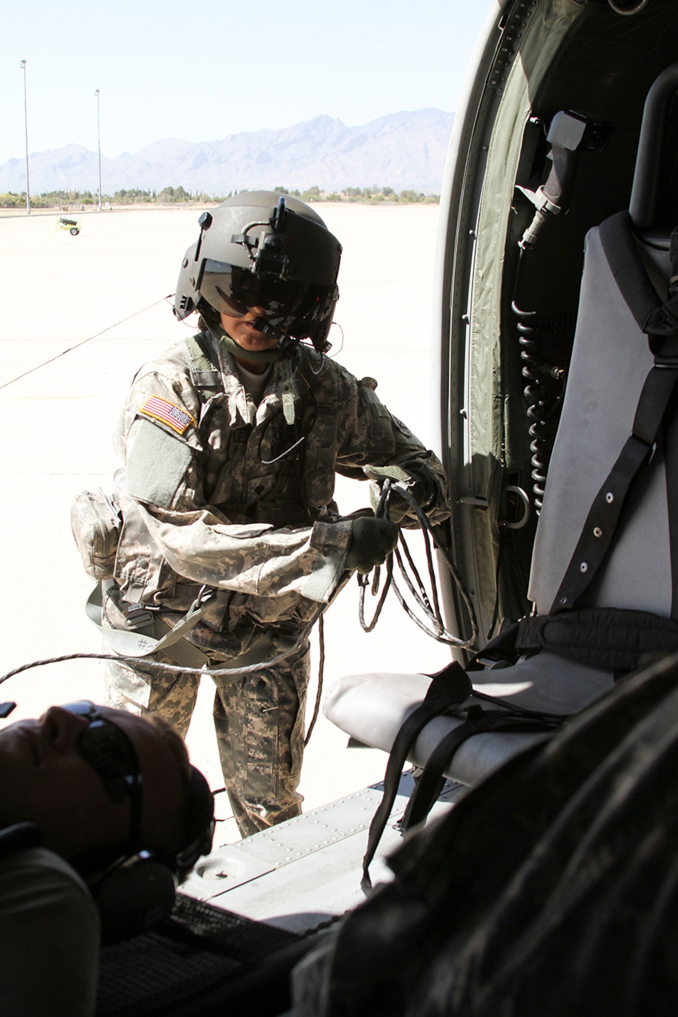 Spc. Nancy Gonzalez, a loadmaster assigned to the 7th Battalion, 158th Aviation Regiment of the Army National Guard, prepares the Blackhawk HH-60M Medevac helicopter for takeoff during a simulated casualty evacuation scenario as part of Exercise ANGEL THUNDER at Davis-Monthan AFB, Ariz., May 7, 2014.  ANGEL THUNDER is a multilateral annual exercise that to supports DoD’s training requirements for Personnel Recovery responsibilities through high–fidelity exercises.  Exercise ANGEL THUNDER focuses on scenarios that rescue forces are likely to face in current and future contingencies—increasing their combat readiness across a range of military options. (U.S. Air Force photo by Tech. Sgt. Heather R. Redman/Released)