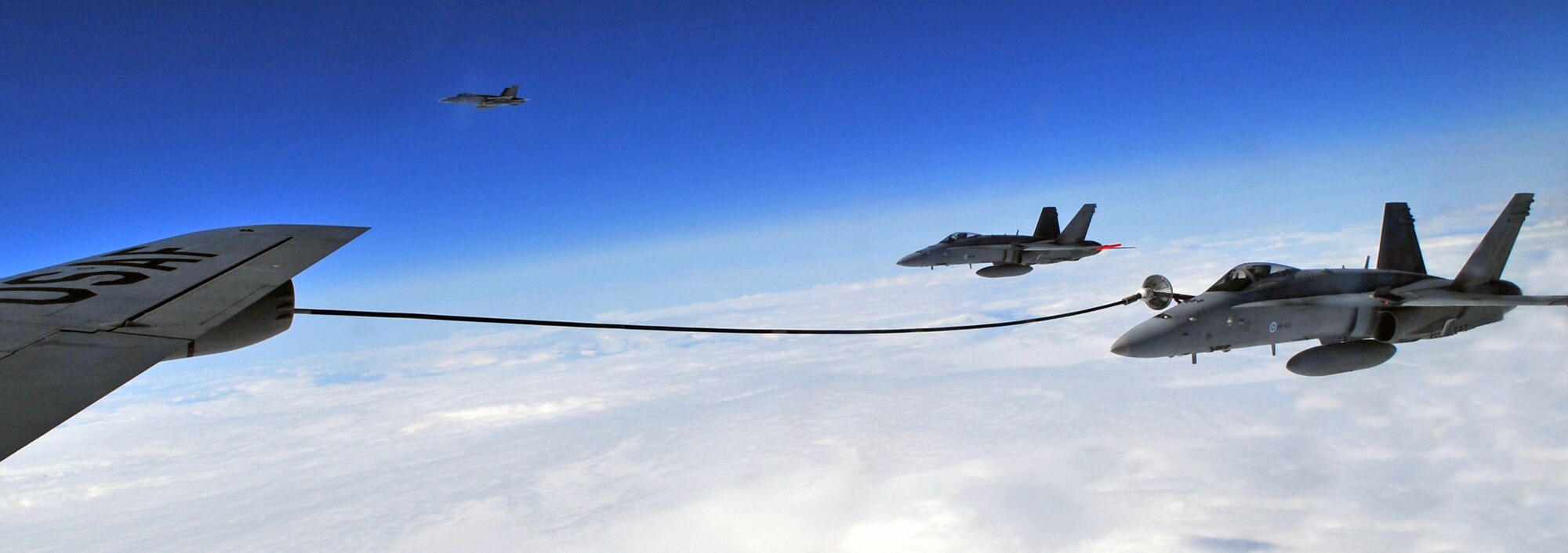 A Finnish air force F-18 Hornet obtains fuel from 100th Air Refueling Wing KC-135 Stratotanker during routine training over Sweden May 7, 2014. Sweden, Norway and Finland train frequently with the U.S. Air Force to maintain proficiency in air refueling missions. (U.S. Air Force photo by Senior Airman Christine Griffiths/Released)