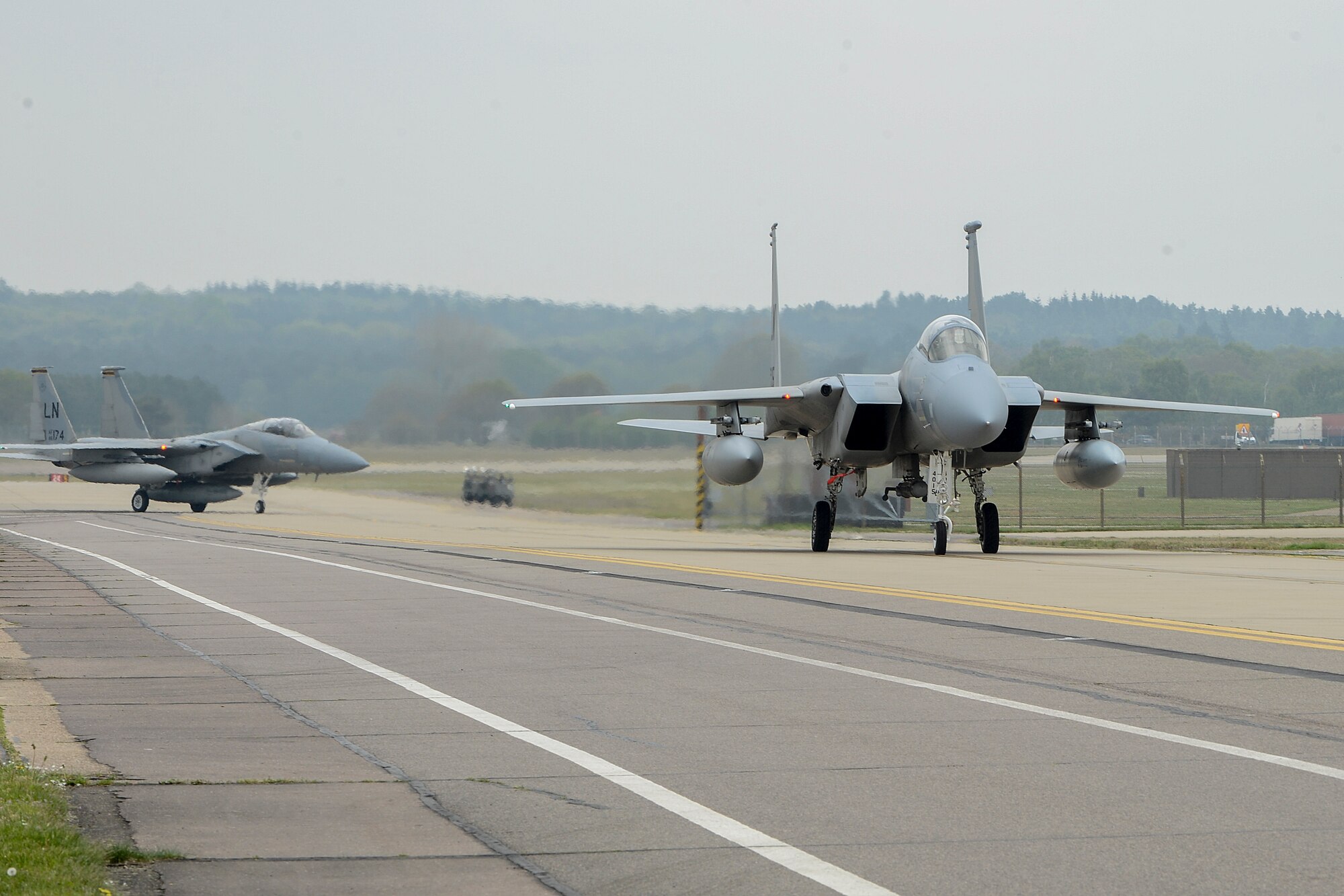 Two F-15C Eagles taxi down the flightline after returning from the 48th Fighter Wing’s participation in Baltic Air Policing at Royal Air Force Lakenheath, May 1, 2014. The U.S. Air Force’s 48th Air Expeditionary Group handed over the reins of NATO’s BAP mission to the air forces of Poland and the United Kingdom during a ceremony at Šiauliai Air Base, Lithuania, April 30, 2014. (U.S. Air Force photo by Airman 1st Class Trevor T. McBride)
