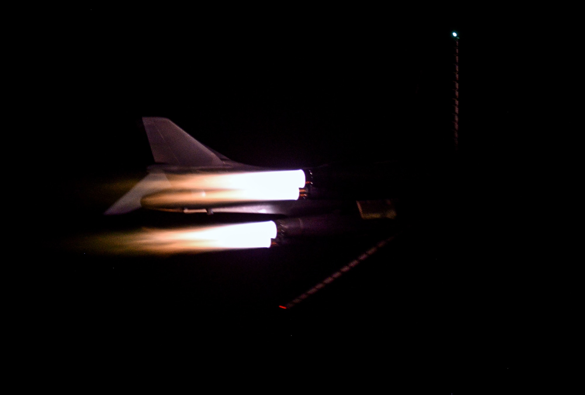 A B-1B Lancer deployed from Ellsworth Air Force Base, South Dakota,flies a night sortie May 4 at Al Udeid Air Base, Qatar. The multi-mission B-1 is the backbone of America's long-range bomber force.  The B-1 was initially developed in the 1970s as a strategic bomber and as a replacement to the B-52 Stratofortress. (U.S. Air Force photo illustration/Senior Airman Jared Trimarchi)