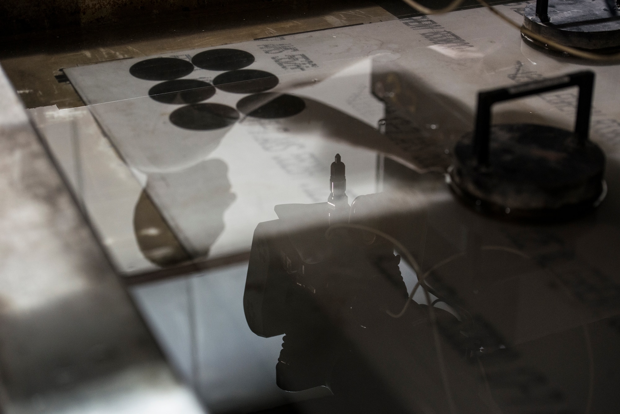 U.S. Air Force Senior Airmen Deryc Coulson, 23d Equipment Maintenance Squadron aircraft metals technology journeyman, operates a water jet machine at Moody Air Force Base, Ga., April 30, 2014. The water jet uses high pressure water to cut two-dimensional shapes out of flat metal surfaces. (U.S. Air Force photo by Airman 1st Class Ryan Callaghan/Released)