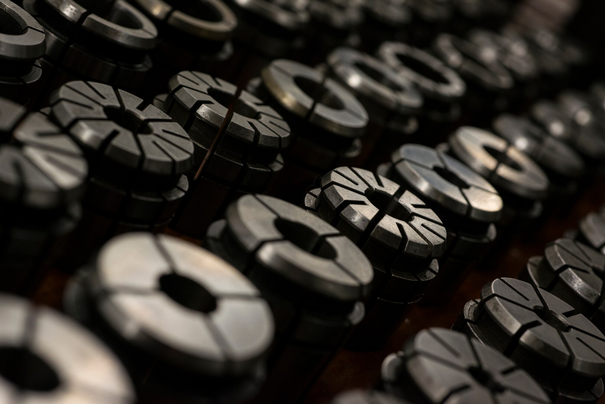 Collets rest in neatly organized lines at Moody Air Force Base, Ga., April 30, 2014. Airmen from the 23d Equipment Maintenance Squadron fabrication flight use collets to hold metal pieces in place while shaping raw metals into new aircraft parts. (U.S. Air Force photo by Airman 1st Class Ryan Callaghan/Released)