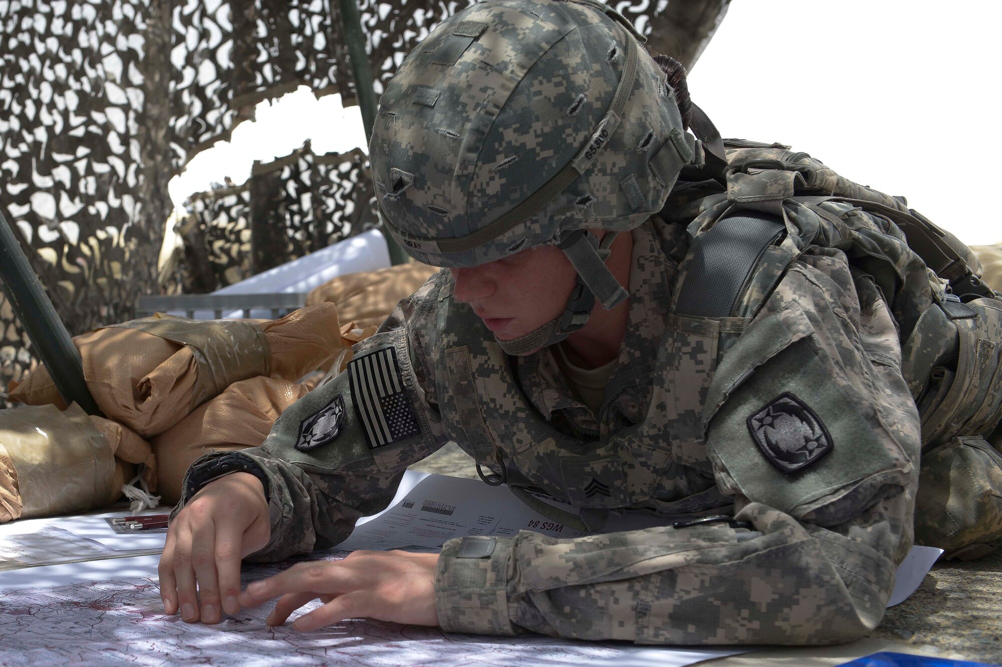 U.S. Army Sgt. Rachel Gray, 1st Battalion, 44th Air Defense Artillery medic, plots a point during the land navigation portion of the Top Notch Brigade Best Warrior competition at Al Udeid Air Base, Qatar, May 1, 2014. The competition was held to recognize the Noncommissioned officer, Soldier, medic and mechanic of the year in the Air Defense units. (U.S. Air Force photo by Master Sgt. Marcelo Joniaux)