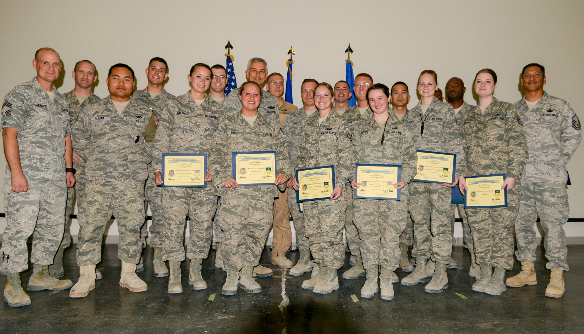 Airmen from a Community College of the Air Force recognition ceremony pose for a group photo May 5, at the Blatchford-Preston Complex theater Al Udeid Air Base, Qatar.  The Community College of the Air Force is a regionally-accredited school, and CCAF degrees are only offered to Air Force service members. Tuition assistance will cover many courses, through both on-campus and distance learning schools. The Base Education and Training Office are open from 8:00 a.m. until 8:00 p.m., Monday through Saturday and Sunday from 12pm until 6, and they can provide additional information on educational opportunities afforded to service members. The online Air Force Virtual Education Center, which can be accessed through the Air Force Portal, can provide additional information as well. (U.S. Air Force photo/Senior Airman Colin Cates)