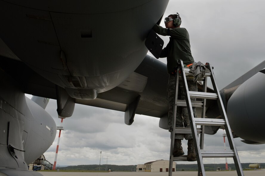 U.S. Air Force Staff Sgt. Paul Coblentz, 726th Air Mobility Squadron crew chief from Milwaukee, performs engine oil servicing on a U.S. Air Force C-17 Globemaster III Cargo Aircraft at Spangdahlem Air Base, Germany, May 7, 2014. The C-17 is the newest, most flexible cargo aircraft to enter the airlift force. (U.S. Air Force photo by Senior Airman Alexis Siekert/Released)
