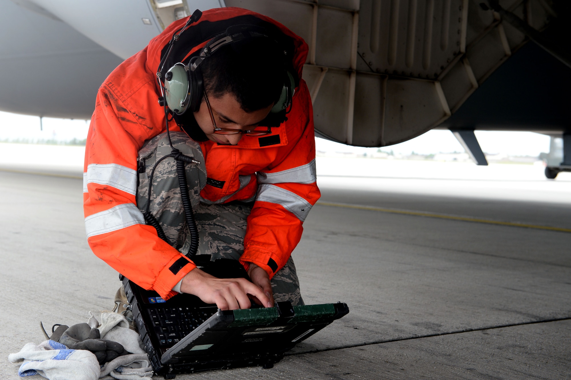 U.S. Air Force Senior Airman Nestor Fraga, 726th Air Mobility Squadron crew chief from Crossville, Tenn., references his Digital Technical Order System during a post-flight inspection of a U.S. Air Force C-17 Globemaster III Cargo Aircraft at Spangdahlem Air Base, Germany, May 7, 2014. Crew chiefs use their DTOS for reference to all maintenance practices. (U.S. Air Force photo by Senior Airman Alexis Siekert/Released)