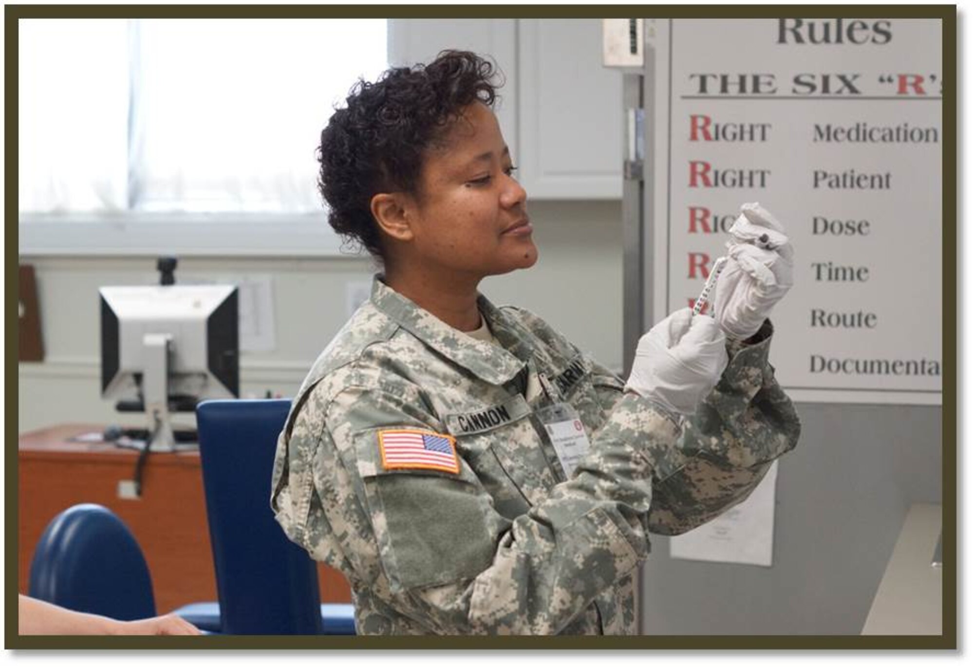 Army Capt. Tanya Cannon, Immunization Section officer in charge, prepares a syringe. National Nurses' Week celebrates healthcare professionals like Cannon for hard work they perform day after day. (Courtesy photo/Released)