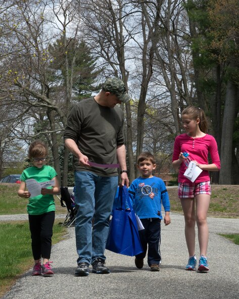 HANSCOM AIR FORCE BASE, Mass. – Alex Seguin, Air Force Office of Special Investigations, and his children, (left to right) Catherine, Andrew and Elisabeth, walk through Castle Park during Hanscom’s Walk and Talk May 3. The event, held as part of the Month of the Military Child and hosted by Hanscom Youth Programs, encouraged families to share a few hours to discuss and explore fun and engaging topics that were provided by members of the Integrated Delivery System team. The IDS, or helping agencies, support members of all services and Department of Defense civilians through a variety of programs such as the Chapel, Youth Programs, Equal Opportunity, Airman and Family Readiness Center and more. (U.S. Air Force photo by Walter Santos) 