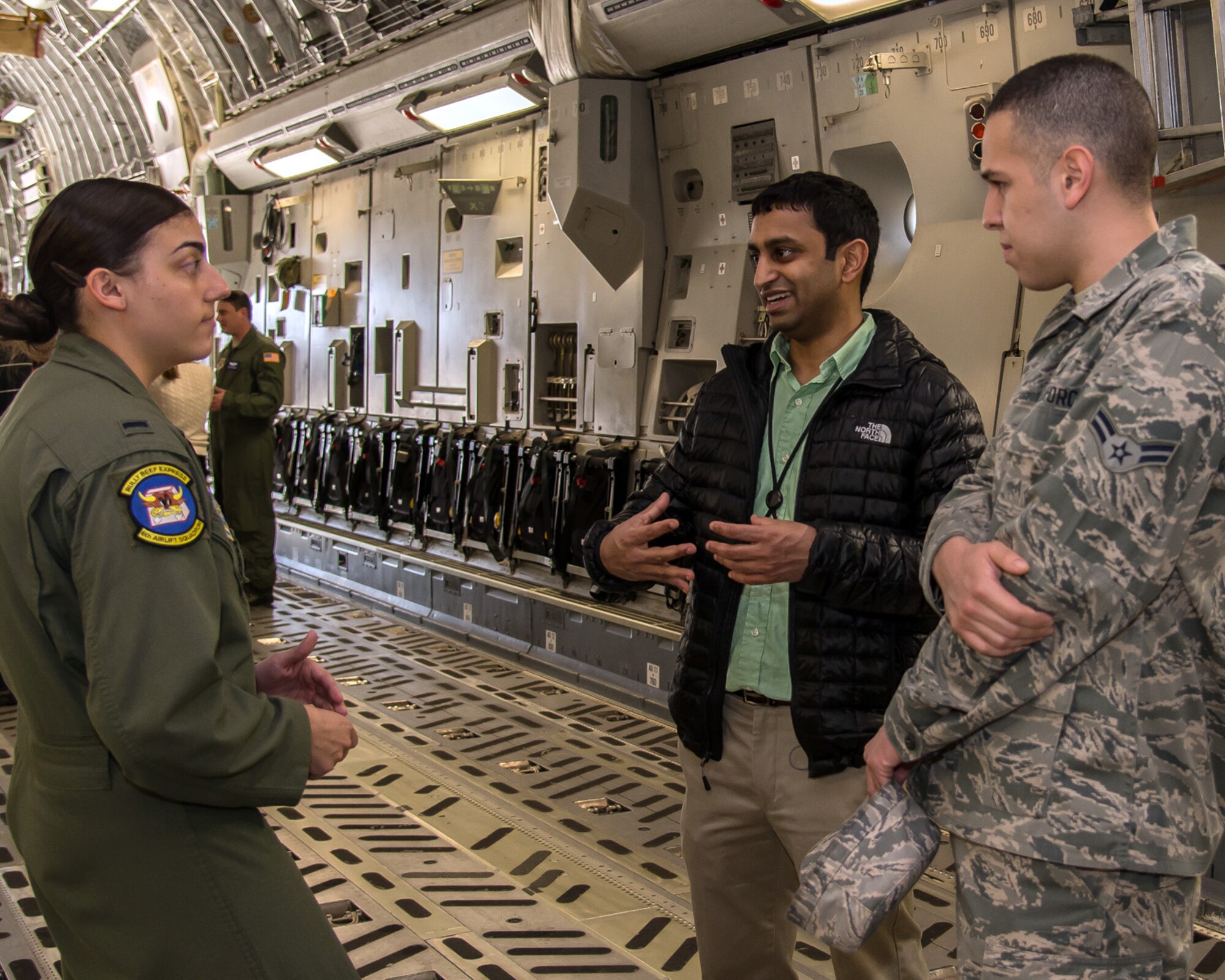 HANSCOM AIR FORCE BASE, Mass. – 1st Lt. Maria Juliano, 305th Operations Support Squadron executive officer, discusses the mission of the 305th Operations Group to Alrik Patel, Communication, Navigation and Surveillance -- Air Traffic Management Control Program, and Airman 1st Class Michael Mejia, 66th Comptroller Squadron, on a C-17 Globemaster III assigned to Joint Base McGuire in N.J., May 1. Company Grade Officers, junior enlisted and Junior Force Council members were invited to tour the aircraft, participate in a question and answer session by crew members on their mission and operational experiences. The aircraft was coordinated locally by Col. Norman “Joe” Leonard to provide Hanscom personnel, in particular first-term enlisted and officers, an opportunity to learn more about other major commands within the Air Force. (U.S. Air Force photo by Walter Santos)