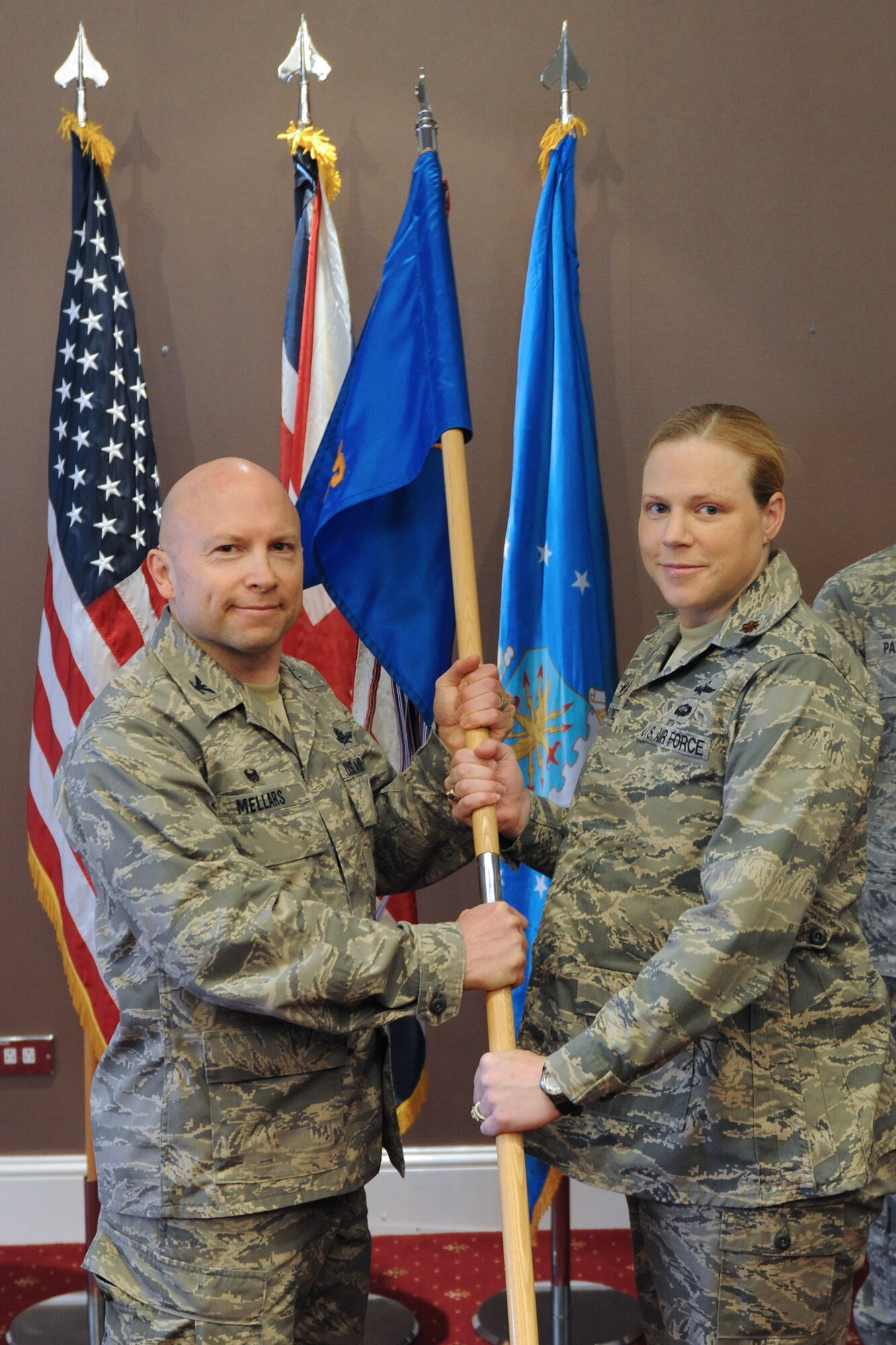 Maj. Kelly Roxburgh-Martinez assumes command of the 422nd Communications Squadron from Col. Doug Mellars, 422nd Air Base Group commander, during an assumption of command ceremony at the Croughton Crown April 24. (U.S. Air Force photo by Capt. Brian Maguire)