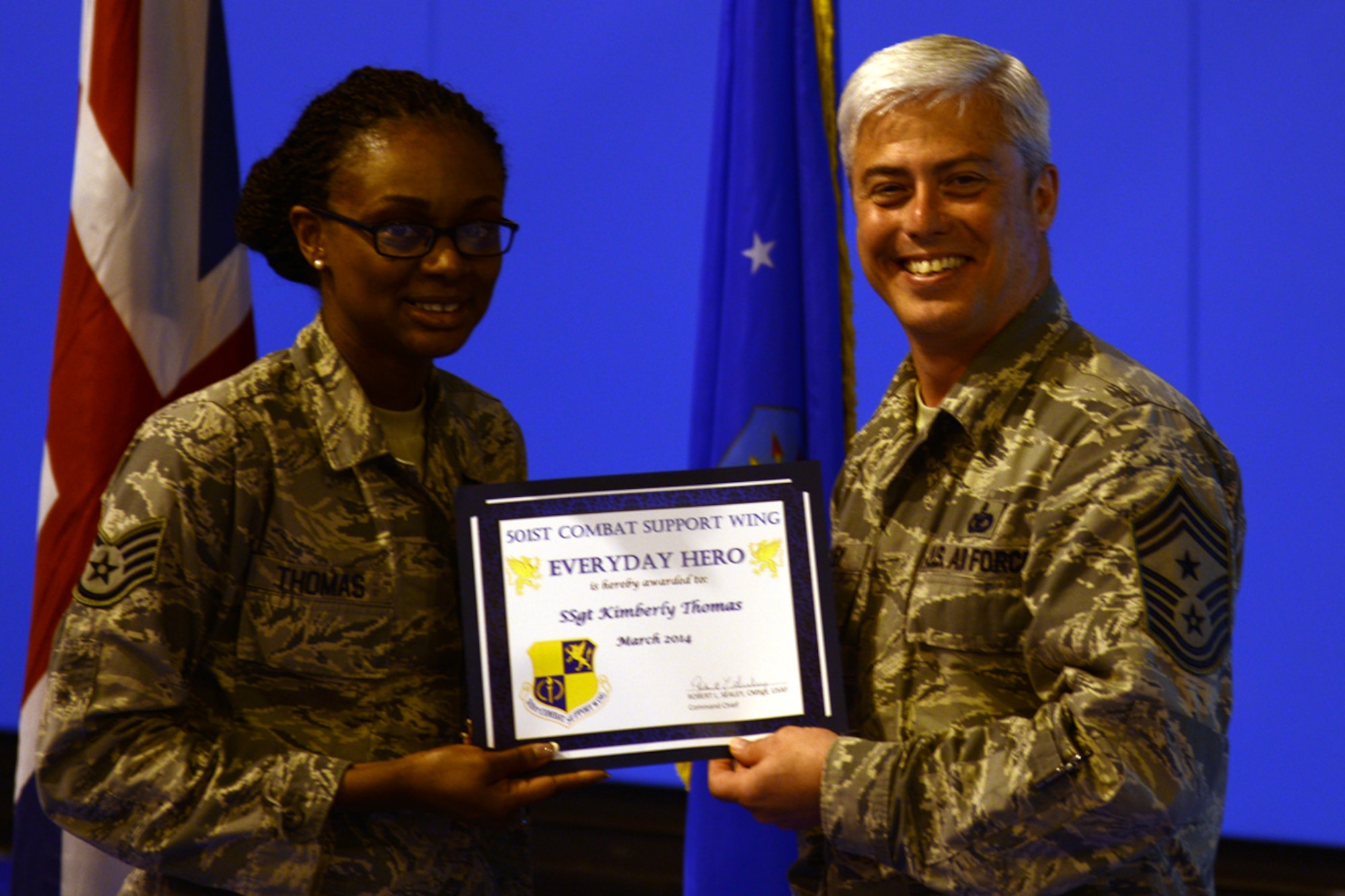 Chief Master Sgt. Robert Sealey, 501st Combat Support Wing command chief, presents Staff Sgt. Kimberly Thomas, 422nd Air Base Squadron military personnel office force management NCOIC, with an Everyday Hero award April 17. Thomas supports the personnel and administrative actions for all Airmen in the 422nd Air Base Group.

She entered the Air Force in June 2008 hoping to travel and see the world. Thomas is also currently working on her Bachelors degree. (U.S. Air Force photo by Tech. Sgt. Chrissy Best)
