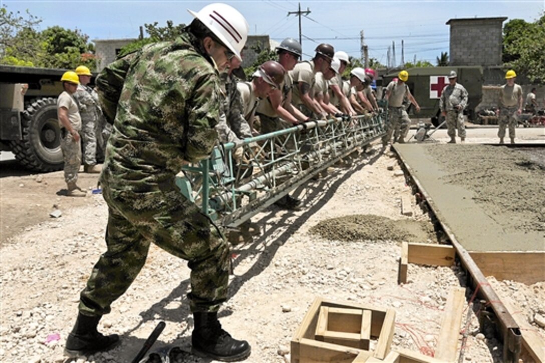 U.S. and Chilean service members level a new medical clinic building foundation during Beyond the Horizon 2014 in Barahona, Dominican Republic, April 24, 2014. The mission provides humanitarian aid assistance to Latin American countries to improve the quality of life for residents. 