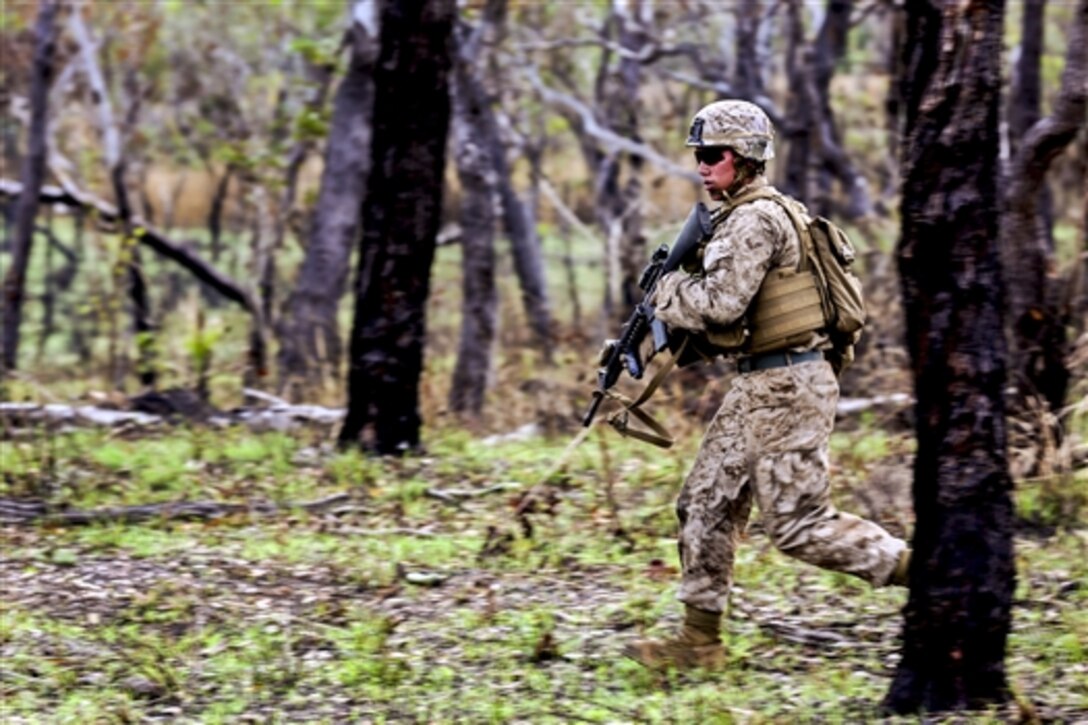 U.S. Marine Corps Lance Cpl. Alfonso Navarro moves through the woods toward his next objective during a live-fire exercise on Kangaroo Flats Training Area in Darwin, Australia, May 1, 2014. Navarro, an infantryman, is assigned to Bravo Company, 1st Battalion, 5th Marine Regiment, Marine Rotational Force Darwin. The Marines used an Australian course of fire, conducting static and kinetic firing drills to strengthen unit cohesion and basic marksman skills. 