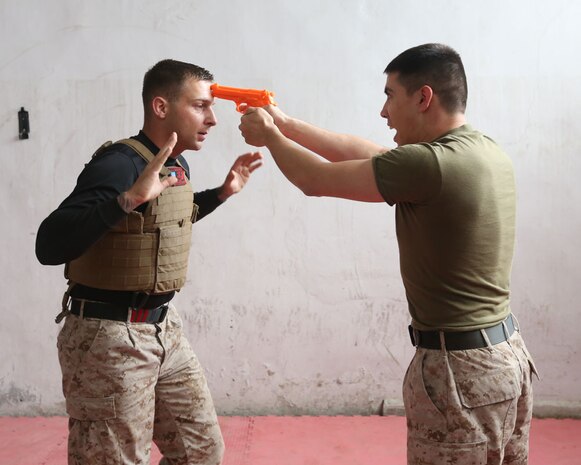 Staff Sgt. William Mullen prepares to disarm Sgt. James Hall to demonstrate a technique from the Marine Corps Martial Arts Program  during an enlisted leadership seminar hosted by the 4th Intervention Regiment in Beirut, Lebanon on March 13, 2014. During the seminar, Marines from Command Element Marine Forces Central Command Forward and soldiers from the 4th Intervention Regiment discussed leadership principles and the role of Non-Commissioned Officers in military units. (U.S. Marine Corps photo by; Sgt James A. Hall, CE MARFOR CENTCOM (FWD) Combat Camera/Released)