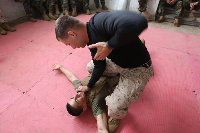 Sgt. Ahmed Khalil is thrown to the ground by Staff Sgt. William Mullen to demonstrate a technique from the Marine Corps Martial Arts Program  during an enlisted leadership seminar hosted by the 4th Intervention Regiment in Beirut, Lebanon on March 13, 2014. During the seminar, Marines from Command Element Marine Forces Central Command Forward and soldiers from the 4th Intervention Regiment discussed leadership principles and the role of Non-Commissioned Officers in military units.  (U.S. Marine Corps photo by; Sgt James A. Hall, CE MARFOR CENTCOM (FWD) Combat Camera/Released)