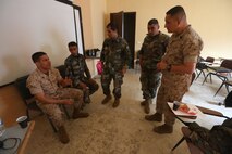 Sgt. Ahmed Khalil translates for soldiers from the 4th Intervention Regiment and  Sgt. Maj. Mario Marquez during  an enlisted leadership seminar hosted by the 4th Intervention Regiment in Beirut, Lebanon on March 10, 2014., Lebanon on March 11, 2014. During the seminar, Marines from Command Element Marine Forces Central Command Forward and soldiers from the 4th Intervention Regiment discussed leadership principles the role of Non-Commissioned Officers in military units. (U.S. Marine Corps photo by; Sgt James A. Hall, CE MARFOR CENTCOM (FWD) Combat Camera/Released)