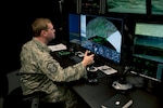 A member of the 146th Air Support Operations Squadron (ASOS), participates in training utilizing the Air National Guard Advanced Joint Terminal Attack Controller Training System (AAJTS) during an unveiling of the first operational AAJTS in the nation at Will Rogers Air National Guard Base in Oklahoma City. The AAJTS is a high-fidelity, fully immersive, simulator designed to support Air National Guard (ANG) Joint Terminal Attack Controller (JTAC) and Combat Controller squadron level continuation, qualification and mission rehearsal training.