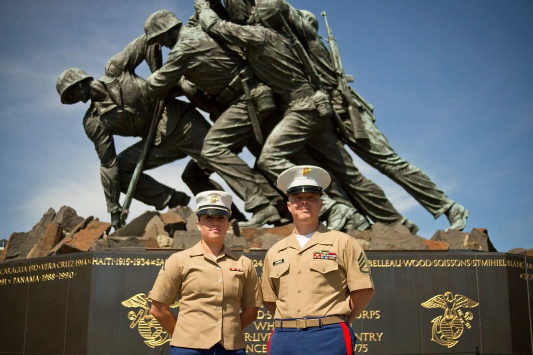 U.S. Marine Corps Staff Sgt. Joshua Gardner, the staff non-commissioned officer of Recruiting Sub-Station Glen Burnie, Marine Corps Recruiting Station Baltimore, and a native of Norfolk, Va., right, stands with the first Marine he recruited while on recruiting duty, Lance Cpl. Carly Jones, a flight control systems technician with Marine Aviation Logistics Squadron 39, Marine Aircraft Group 36, 3rd Marine Aircraft Wing, and a native of El Paso, Texas, at the Iwo Jima Memorial in Arlington, Va., May 5, 2014. Gardner, along with two other recruiters, reenlisted in the Marine Corps for another four years. (U.S. Marine Corps photo by Sgt. Bryan Nygaard/Released)