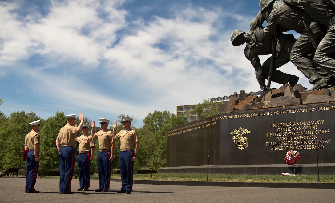 U.S. Marine Corps Maj. Christopher Conner, the commanding officer of Marine Corps Recruiting Station Baltimore, administers the oath of enlistment to Staff Sgt. Joshua Gardner, Staff Sgt. Richard Perreault, and Staff Sgt. James Watson, all recruiters with RS Baltimore, at the Iwo Jima Memorial in Arlington, Va., May 5, 2014. All the recruiters reenlisted to continue serving on recruiting duty with RS Baltimore and to send America’s best and brightest to Marine Corps Recruit Depot Parris Island, S.C. (U.S. Marine Corps photo by Sgt. Bryan Nygaard/Released)