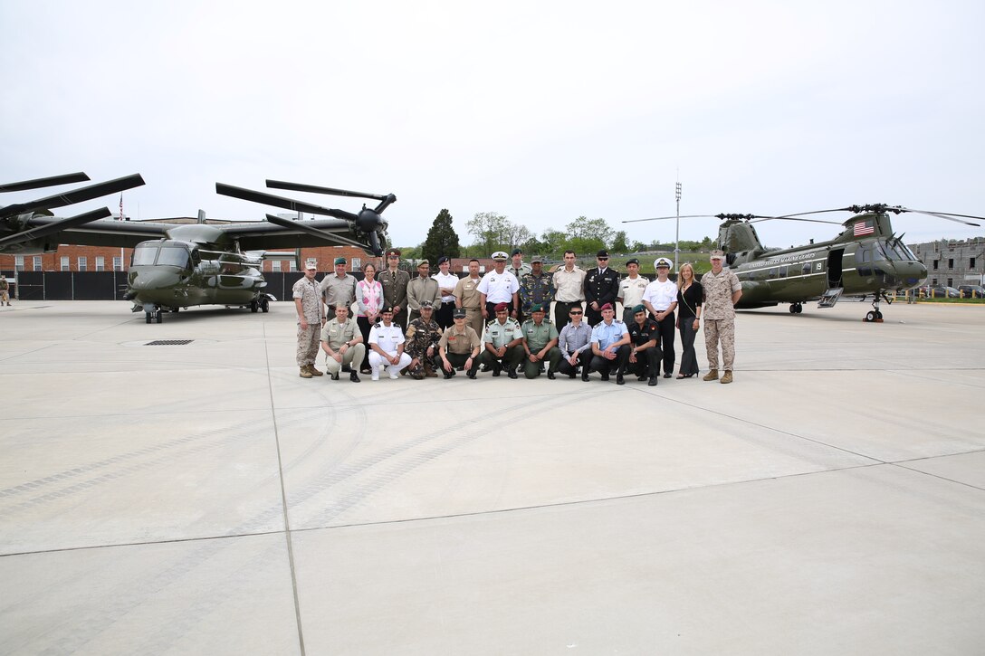 International Officers who are students at the Command and Staff College, their faculty advisors, Sgt. Maj. George Sanchez, the command sergeant major at Marine Corps Air Facility Quantico, and Lt. Col. Vincent Ciuccoli, the commanding officer at MCAF, pose for a photo in front of an MV-22 Osprey and CH-46E Sea Knight on May 5, 2014. The students were getting a tour of the facility and learning what goes into running it.