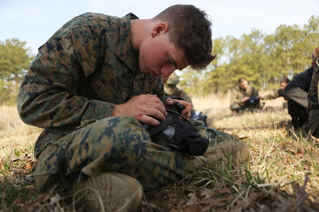 Private Zachary K. Guzdek, a motor transportation operator with 2nd Tank Battalion, 2nd Marine Division, and Oakfield, N.Y., native, safety checks his M50 field protective mask before entering a gas chamber in Ft. Pickett, Va., April 4, 2014. Marines with the battalion completed individual survival standards as part of their annual training requirement for.