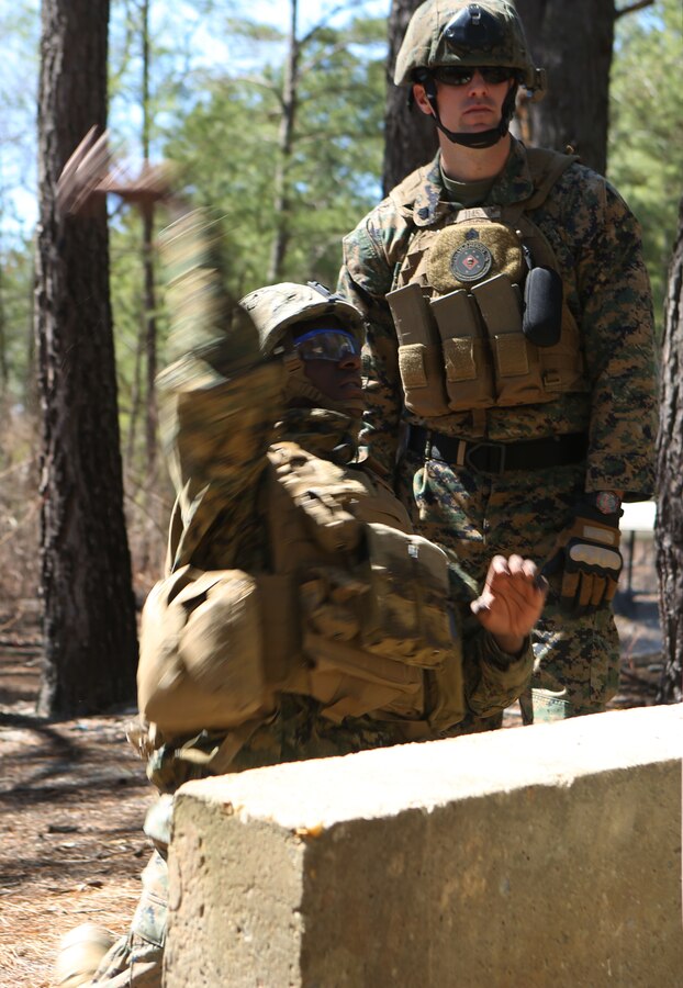 Lance Cpl. Jean Boris Mugisha, a driver with Anti-Tank Platoon, 2nd Tank Battalion, 2nd Marine Division, from Dayton, Ohio, throws an M69 Training Grenade at Fort Pickett, Va., during a Hand Grenade Familiarization Training March 31, 2014. “Throwing grenades properly and on target is a perishable skill. It’s kind of like throwing a baseball after a year off the field,” said Cpl. Patrick W. Westcott, a Tiverton, R.I. native and team leader with Scout Platoon.