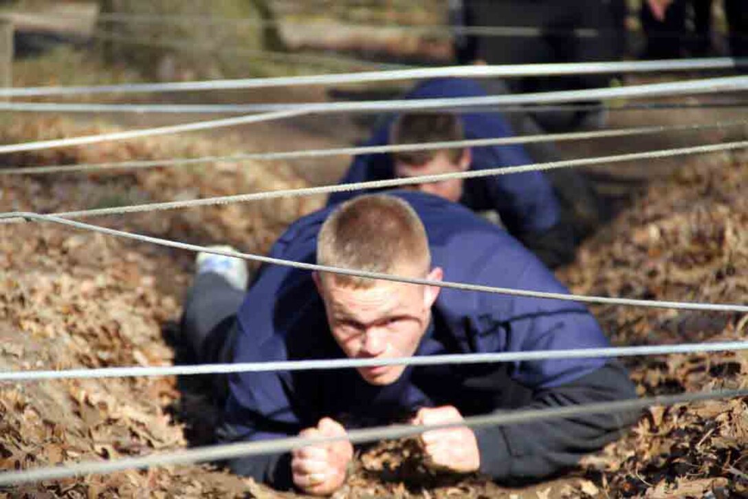 Poolee Drew Tykwinski navigates through one of the obstacles at the obstacle course at the 2014 RS Twin Cities Mini-Bootcamp. During their training, poolees and guests executed the obstacle course, the leadership reactions course and conducted various physical fitness workouts. 