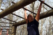 Poolee Maureen Abayare navigates her way through one of the obstacles at the obstacle course aboard the 2014 RS Twin Cities Mini-Bootcamp. Other obstacles included jumping over logs and climbing a rope tower. 