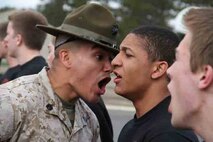 Drill Instructor Staff Sgt. Vincent Aguilar motivates Poolee Davionet L. L. Young during the RS Twin Cities 2014 Mini-Bootcamp. The Three drill instructors at the event stressed out poolees to prepare them for recruit training. 