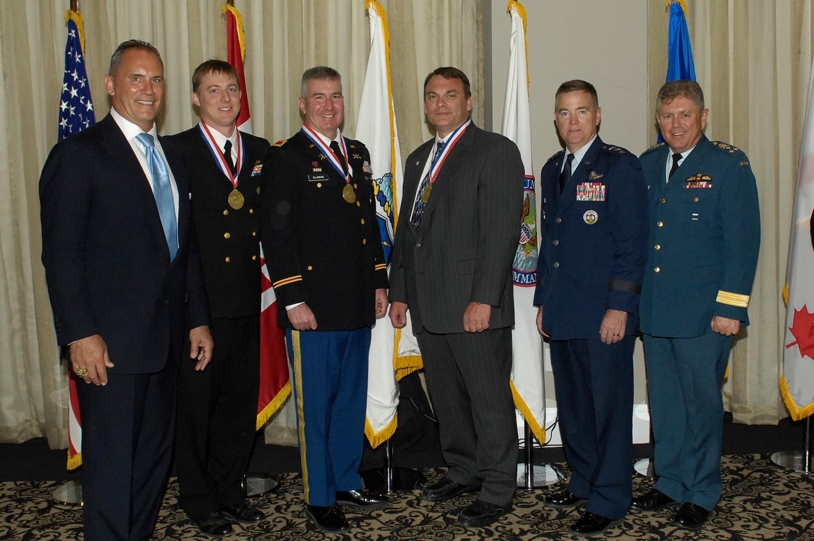 Outstanding NORAD-USNORTHCOM members were recognized during the Missile Warning and Defender of the Year Award Ceremony on May 2nd, 2014 at the Mining Exchange Hotel in Colorado Springs.(l-r) Mr. Rikki Ellison, Founder and Chairman, MDAA, LCDR Tim Ladowicz, Col Fred Clarke, Mr. Jeff Dillemuth, (missing) Lt Col Rickey McCann. They are accompanied by USNORTHCOM Deputy Commander Gen Michael Dubie and NORAD Deputy Commander, Canadian Lt-Gen Alain Parent.
