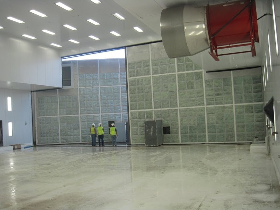 HOLLOMAN AIR FORCE BASE, N.M., -- During the fire protection systems commissioning at Alter Hangar 898, three Corps employees look at the massive hangar door, which is cracked open in anticipation of foam system testing.
Photo by Daniel Garcia, Aug. 24, 2011.
