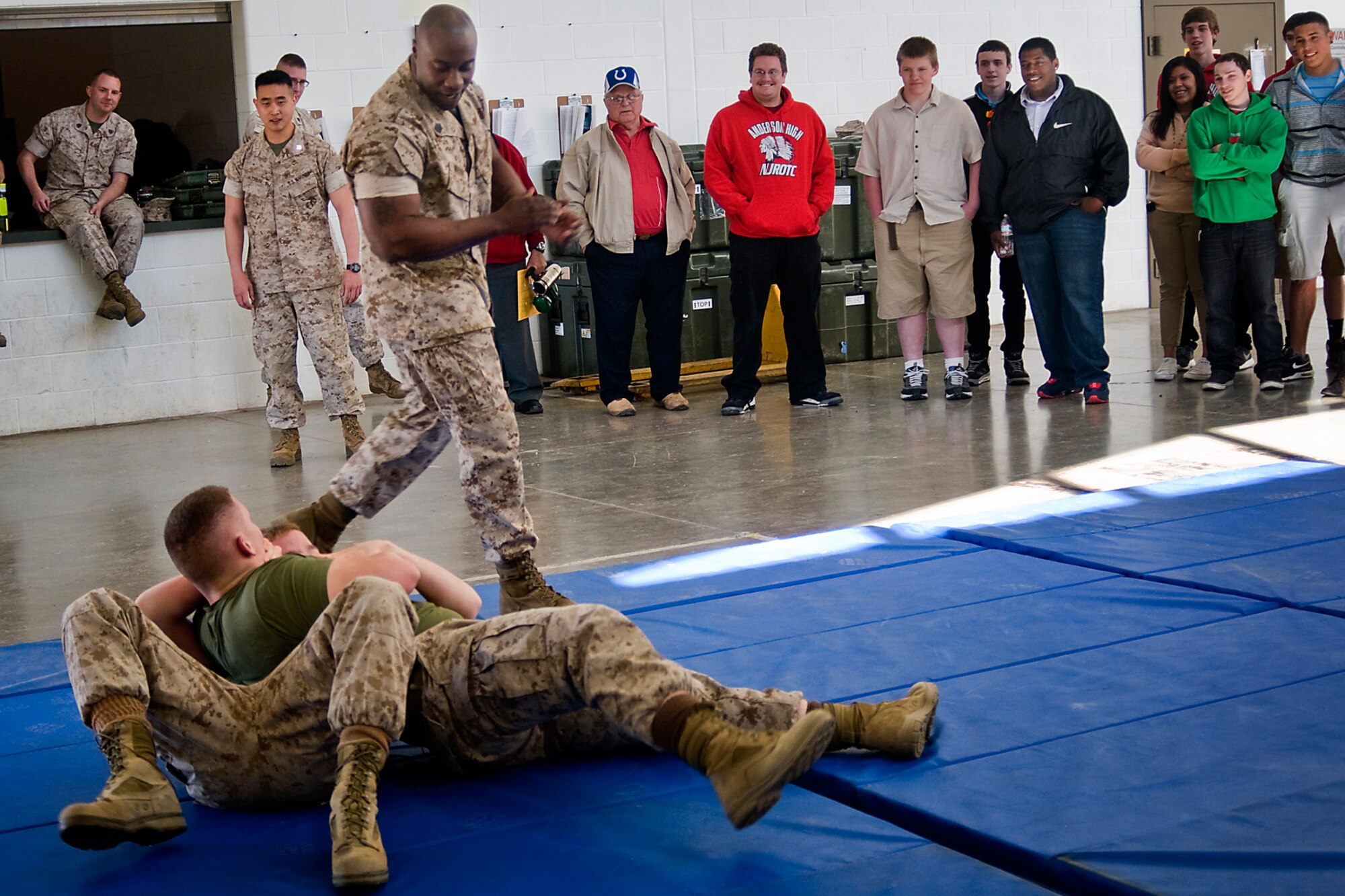 Marine Gunnery Sgt. Cory Korey Wright, instructs as Marine Lance Cpls. Austin Bontrager, top, and Andrew Hall, grapple during a self-defense demonstration at Grissom Air Reserve Base, Ind., April 23, 2014. The Marines from Detachment One, Communication Company, Combat Logistics Regiment 45, 4th Marine Logistics Group, put on the display for Navy Junior ROTC students from Anderson High School, Anderson, Ind. (U.S. Air Force photo/Tech. Sgt. Douglas Hays)
