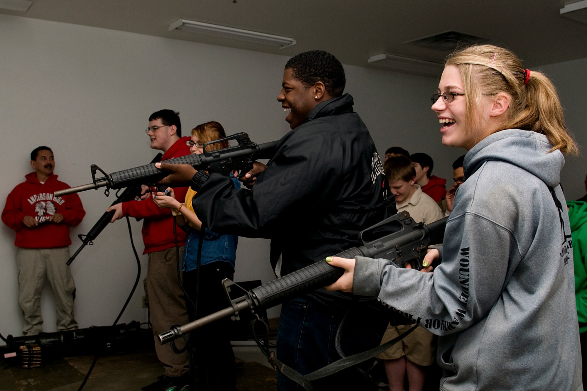 Navy Junior ROTC students from Anderson High School, Anderson, Ind., have fun using a firearms training simulator at the Marine Corps Reserve Center at Grissom Air Reserve Base, Ind., April 23, 2014. Marines from Detachment One, Communication Company, Combat Logistics Regiment 45, 4th Marine Logistics Group gave a tour to the students to give them a better understanding of military life. (U.S. Air Force photo/Tech. Sgt. Douglas Hays)
