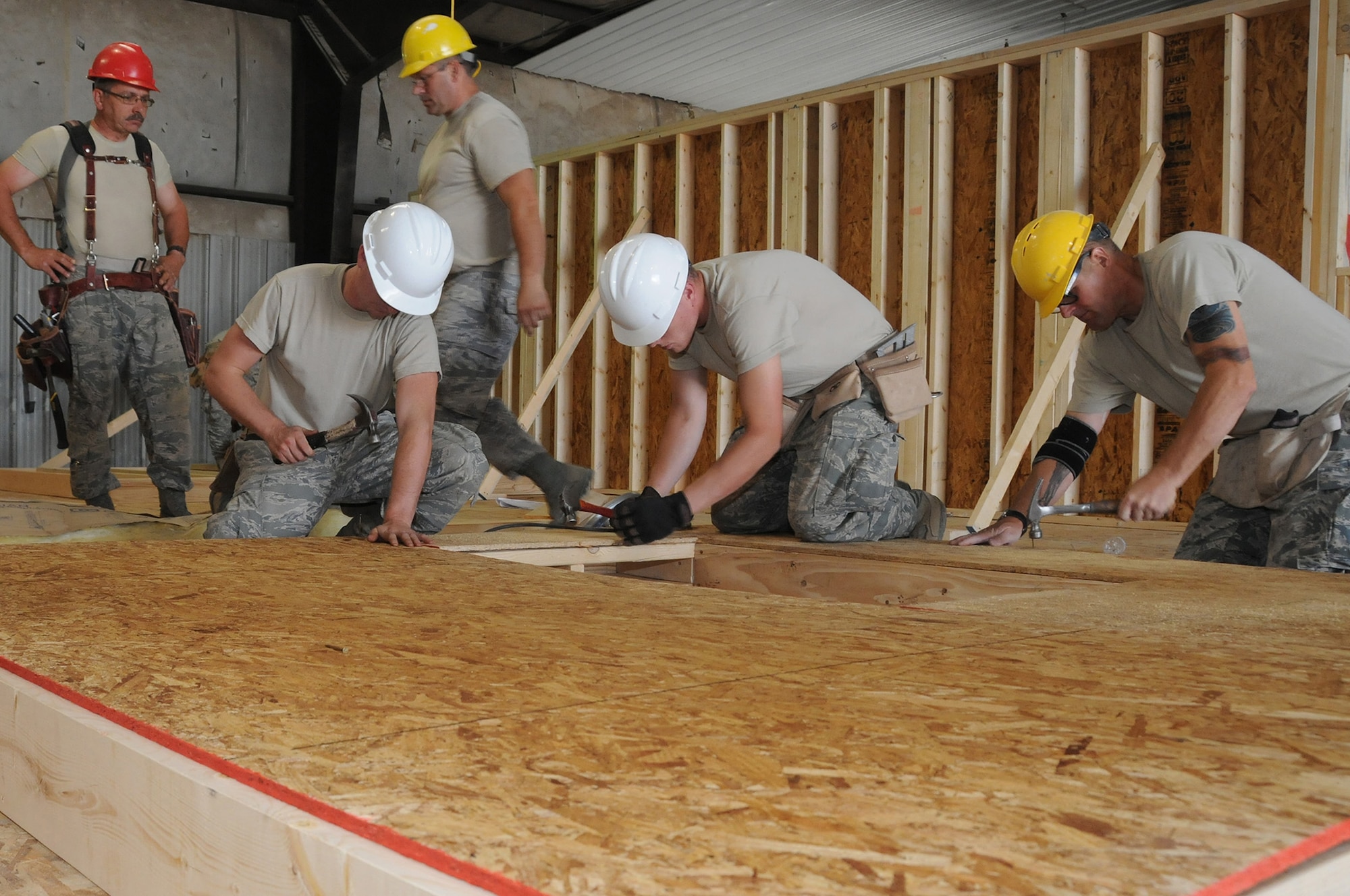 Members of the 101st Civil Engineer Squadron, Maine Air National Guard, build a home for a Navajo family as part of the Innovative Readiness Training mission Operation Footprint in Gallup, N.M., Aug. 15, 2012. About 21 Reservists with the 446th Civil Engineer Squadron, Joint Base Lewis-McChord, Wash., will depart May 10, 2014 to contribute to the operation and improve their skills. Operation Footprint is a multiservice mission comprised of active-duty, Reserve, and National Guard members from Army, Navy and Air Force components focusing on deployment and real-world readiness training preparing for wartime missions in a joint-service environment while simultaneously providing free civil engineering services to the community. (National Guard photo by Tech. Sgt. Melissa E. Chatham/RELEASED)
