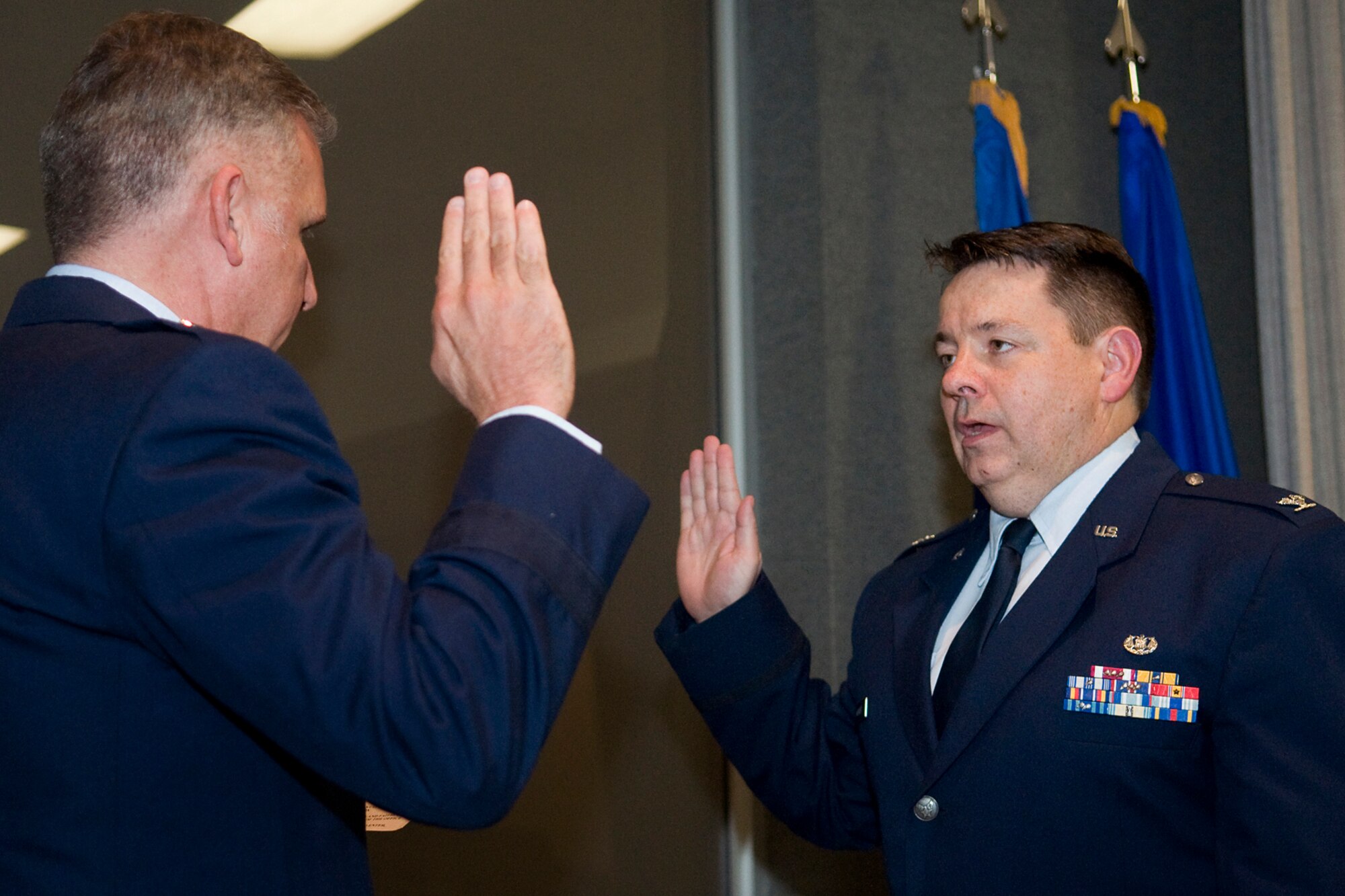 Brig. Gen. John C. Flournoy Jr., 4th Air Force commander, gives an oath of office to a newly promoted Col. Stephen McManus, 434th Air Refueling Wing staff judge advocate, shortly after McManus had his eagle rank insignia pinned on during a special ceremony at Grissom Air Reserve Base, Ind., April 12, 2014. Flournoy presided over the ceremony. (U.S. Air Force photo/Tech. Sgt. Mark R. W. Orders-Woempner)
