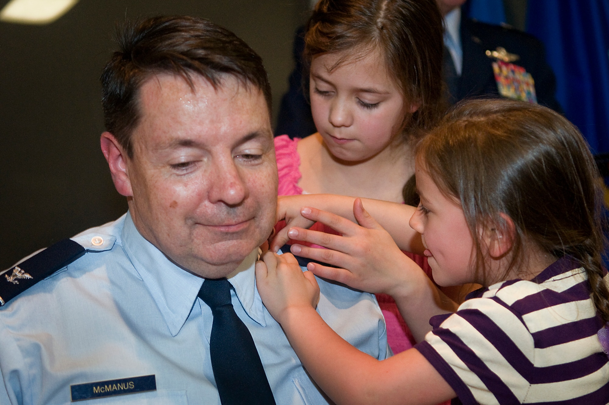 Brenna, right, and Tressa McManus, pin colonel rank on their newly promoted father, Col. Stephen McManus, 434th Air Refueling Wing staff judge advocate, during a special ceremony at Grissom Air Reserve Base, Ind., April 12, 2014. The history of the prestigious rank dates back to around 1505, when the Spanish King Ferdinand reorganized part of his army into twenty units called colunelas. (U.S. Air Force photo/Tech. Sgt. Mark R. W. Orders-Woempner)
