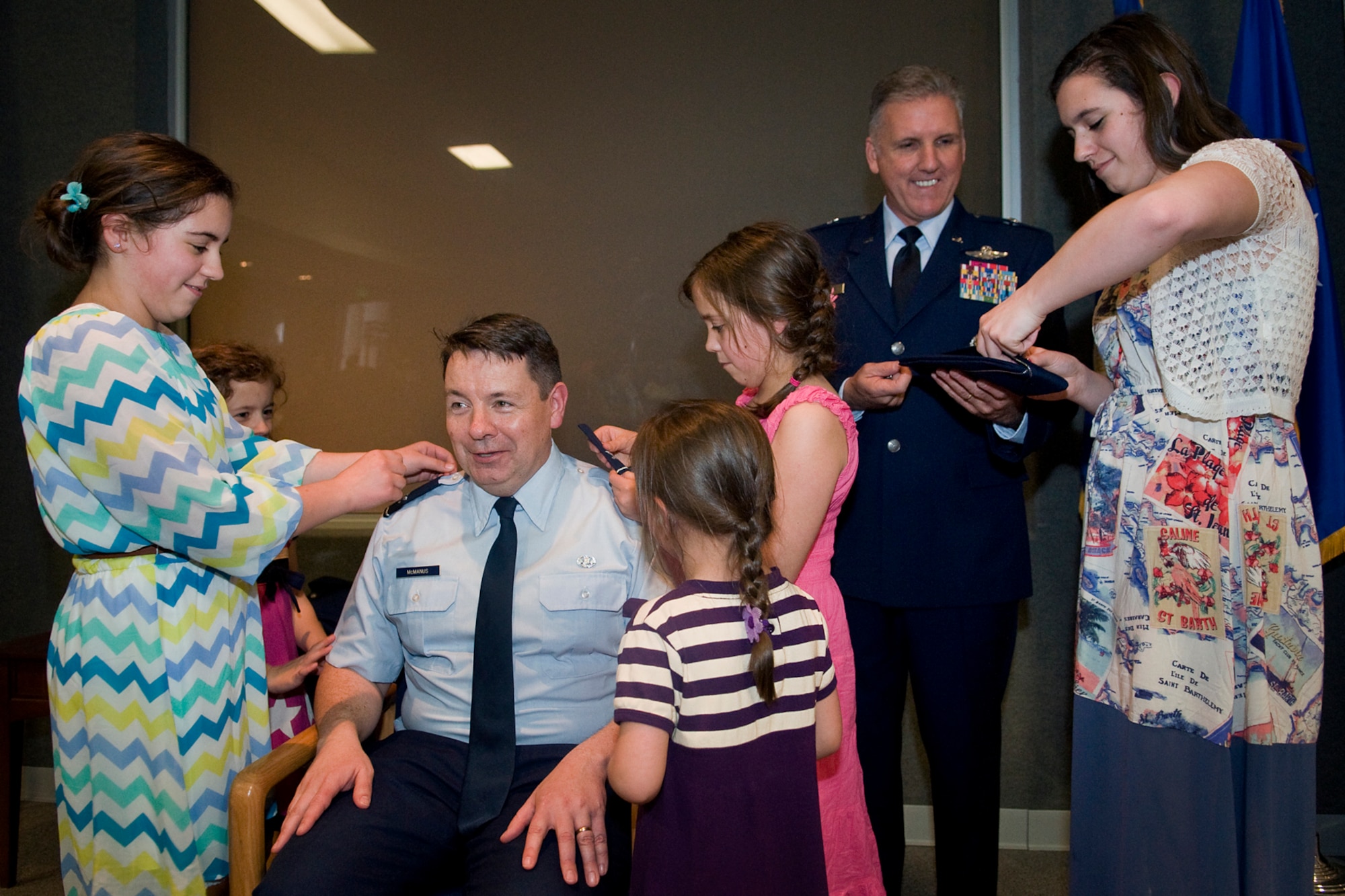Five of the eight children of newly promoted Col. Stephen McManus, 434th Air Refueling Wing staff judge advocate, pin eagle rank insignia on their dad with the help of Brig. Gen. John C. Flournoy Jr., 4th Air Force commander, during a special ceremony at Grissom Air Reserve Base, Ind., April 12, 2014. Picture from left to right are Aisling, Niamh, Tressa, Brenna and Kaileigh McManus. (U.S. Air Force photo/Tech. Sgt. Mark R. W. Orders-Woempner)

