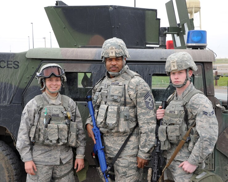 Chief Master Sgt. Phillip L. Easton, 341st Missile Wing command chief (center), poses with Airmen 1st Class Samantha Haase (left) and Robert Martin, 341st Security Forces Squadron response force members, May 6. Easton joined security forces members and performed their duties as a part of a new program. (U.S. Air Force photo / Airman 1st Class Joshua Smoot)