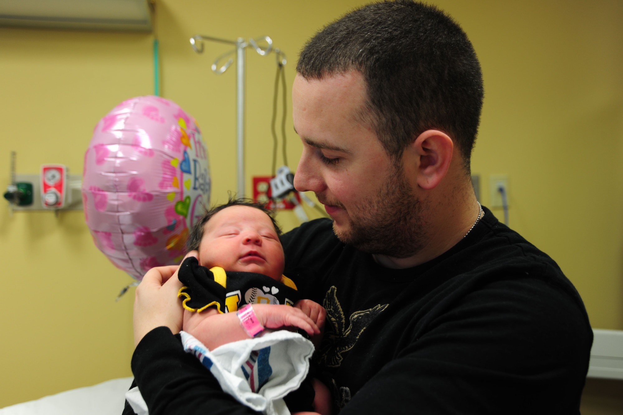 Airman 1st Class Samuel DeWitt embraces his newborn daughter Kynnedie, at MedStar Southern Maryland Hospital on March 31,2014. DeWitt, 79th Medical Staging Squadron diet therapy apprentice, and his wife Kaila said they are thankful Kynnedie’s grandmother, Ginger Preston, survived being in a diabetic coma to witness the birth of her first grandchild. (U.S. Air Force photo / Amber J. Russell)