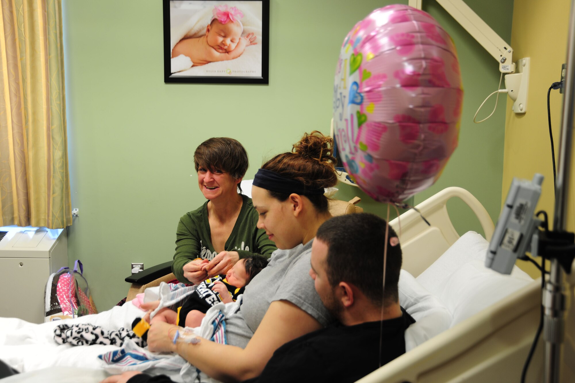 Ginger Preston (left) mother-in-law to Airman 1st Class Samuel DeWitt (right), shares a moment with her first granddaughter Kynnedie at MedStar Southern Maryland Hospital on March 31,2014. DeWitt, 79th Medical Staging Squadron diet therapy apprentice, and his wife Kaila said Preston is their hero. (U.S. Air Force photo / Amber J. Russell)
