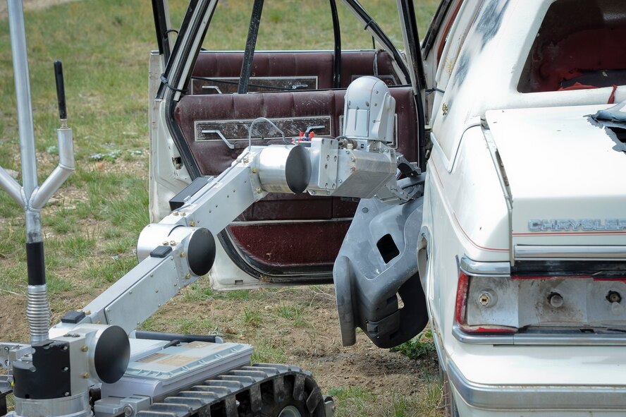 An Air Force Medium-Sized Robot removes contents from a suspected vehicle bomb.  The AFMSR is the primary equipment used by the Explosive Ordnance Disposal teams for dealing with improvised explosive devices. It is used both for searching and remotely removing hazardous items. (U.S. Air Force photo/ Airman 1st Class Joshua Smoot)