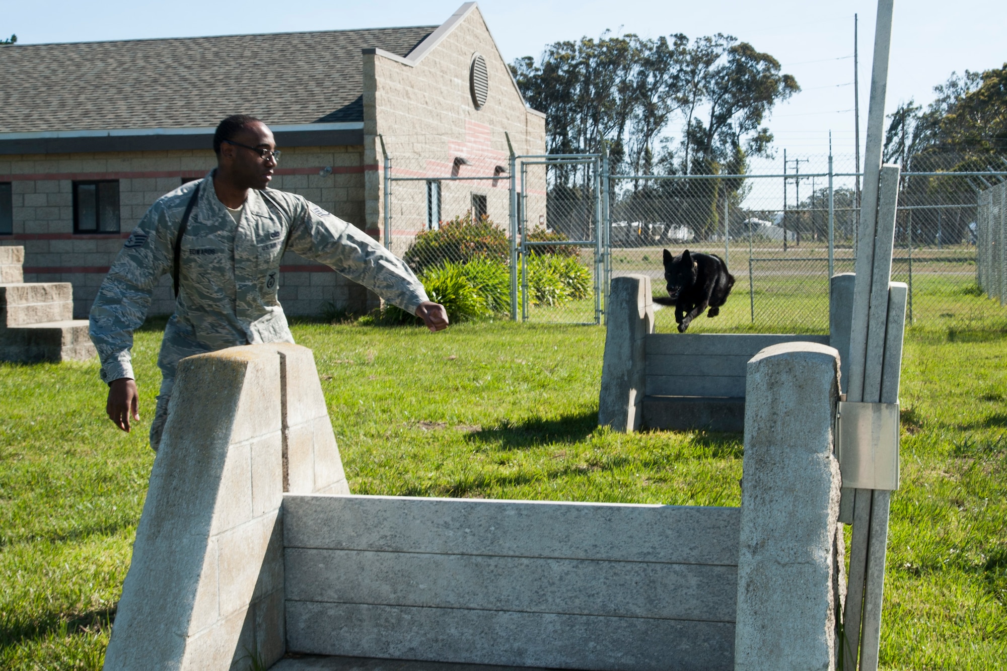 Staff Sgt. Henry Edwards III, 30th Security Forces Squadron military working dog trainer and handler, goes through obedience training with his dog Blecki, April 29, Vandenberg Air Force Base, Calif. Edwards came back from his second deployment and Blecki has been on three deployments within the past three years. (U.S. Air Force photo by Airman 1st Class Yvonne Morales/Released)