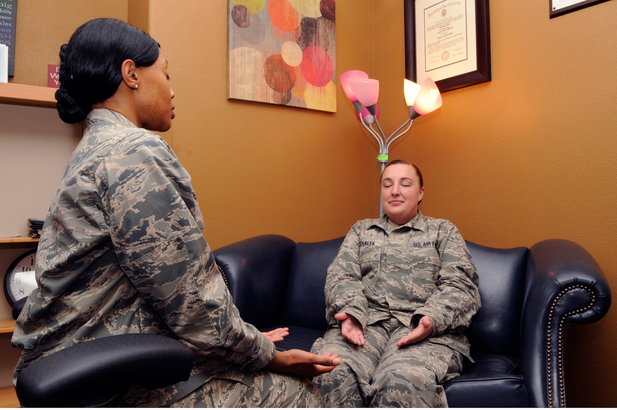 Maj. Crystal McLeod, 30th Medical Operations Squadron family advocacy
officer, and Staff Sgt. Rebecca Michalek, 30th MDOS mental health element
noncommissioned officer in-charge, demonstrate relaxation training, May 7,
Vandenberg Air Force Base, Calif. In addition to treating military related
post-traumatic stress disorder, mental health has the capability to assist
with a wide variety of ailments. (U.S. Air Force photo by Senior Airman
Shane Phipps/Released)

