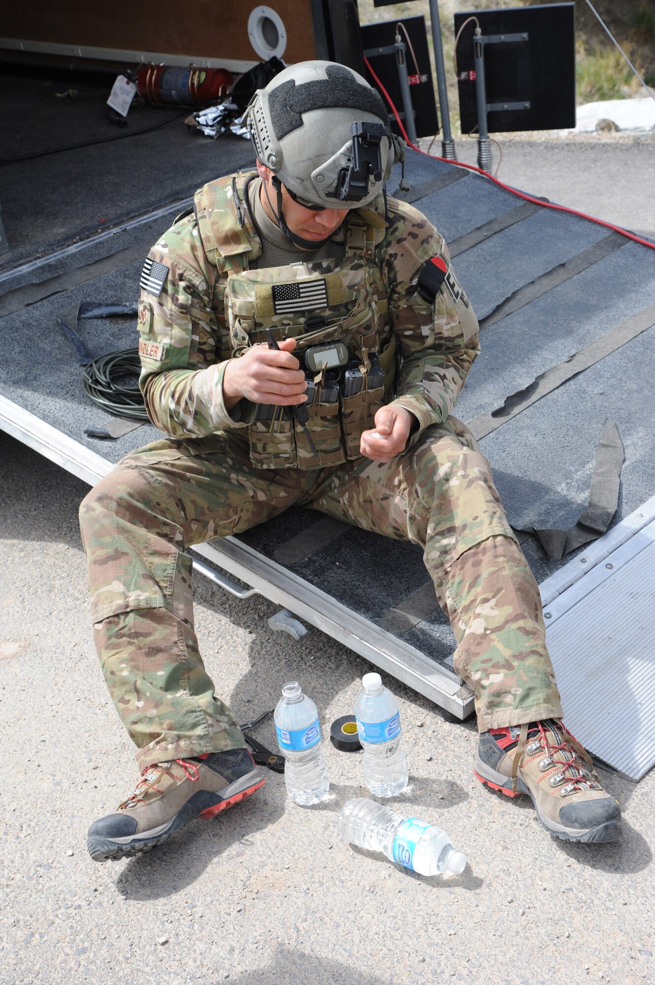 Senior Airman Randy Shandler, 341st Civil Engineer Squadron Explosive Ordnance Disposal technician, prepares an explosive water bottle charge to defeat an improvised explosive device.  Currently, Malmstrom Air Force Base has 17 personnel assigned to the 341st CES EOD team, with several of those overseas doing what they were training for during this exercise. (U.S. Air Force photo/ Airman 1st Class Joshua Smoot)