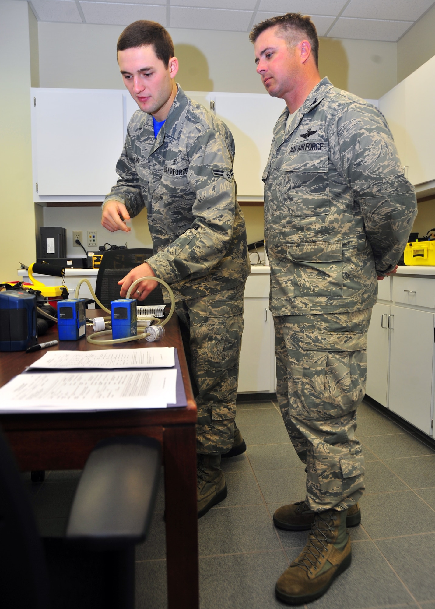 Airman 1st Class James Hunt, 325th Aerospace Medicine Squadron bioenvironmental engineering technician, shows Col. David E. Graff, 325th Fighter Wing commander, some of the tools he uses on a weekly basis May 9 at the 325th Medical Group building. Hunt was chosen to be shadowed by Graff for the Airman Shadow Program. (U.S. Air Force photo by Airman 1st Class Sergio A. Gamboa) 