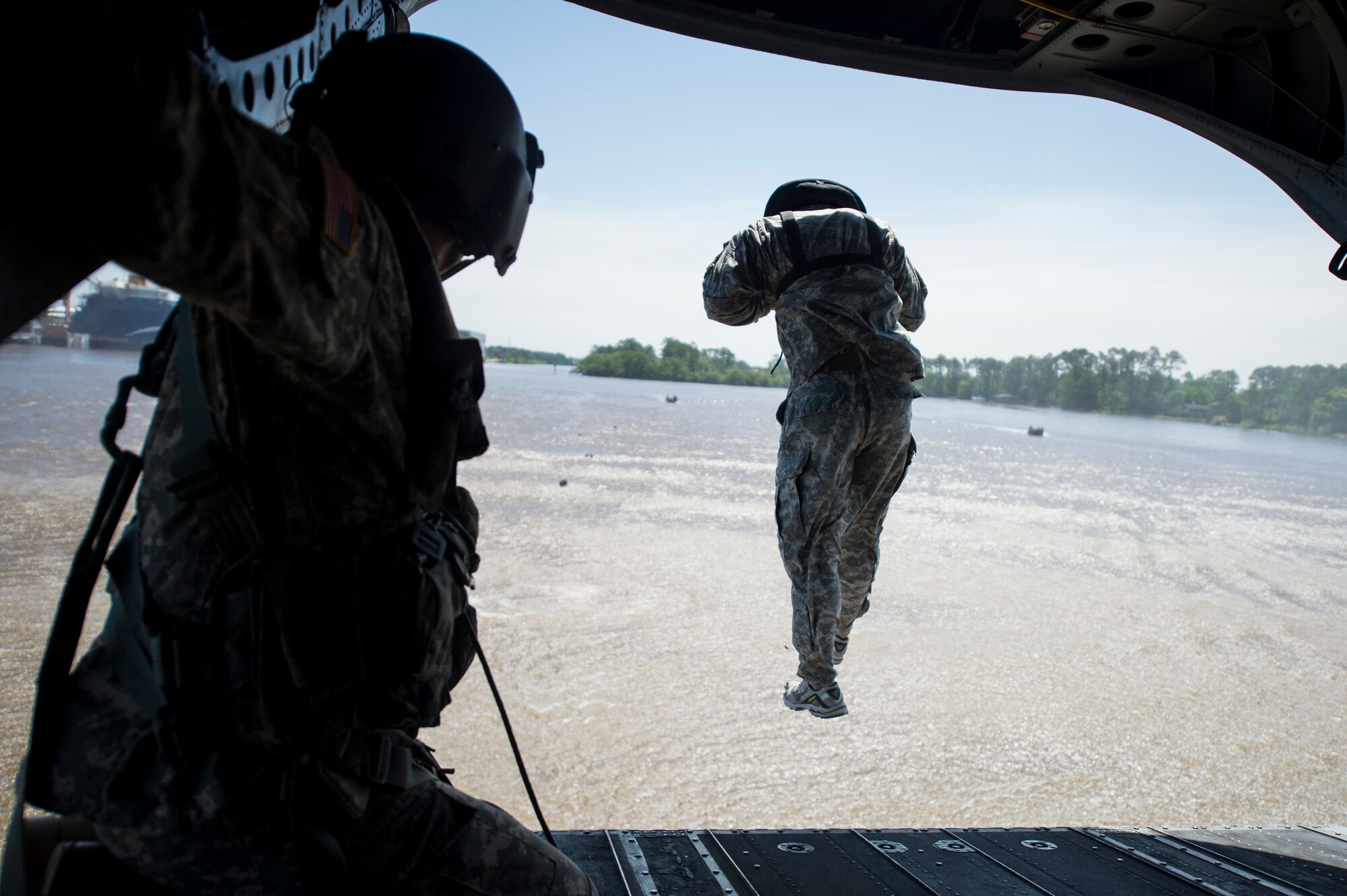 A U.S. Soldier with the 20th Special Forces Group jumps from a CH-47 Chinook helicopter for helocast training, an airborne technique used by small forces to insert into a military area of operations, during Emerald Warrior 14 in Gulfport, Miss., April 30, 2014. Emerald Warrior is a U.S. Special Operations Command-sponsored two-week joint/combined tactical exercise designed to provide realistic military training in an urban setting. (U.S. Air Force photo by Senior Airman Jodi Martinez)